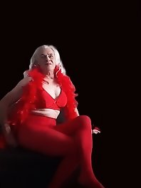 A girl in tart clothes plays with a dildo and simulates sex